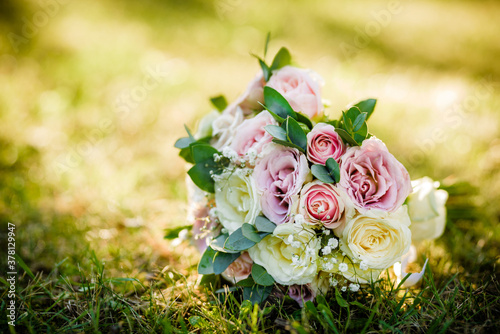 Beautiful wedding bouquet on the ground . Fresh roses bouquet