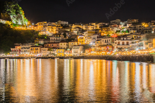 Night panorama or nightscape of the city of Parga, Greece. Looking across the bay towards traditional houses and syvota castle. © Anze