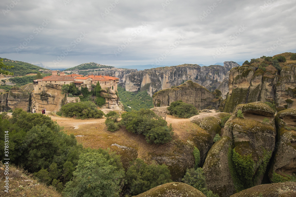 Drone Panorama of  Varlaam  Monastery. Beautiful scenic panoramic view, ancient traditional greek building on the top of huge stone pillar in Meteora,Thessaly, Greece, Europe on a cloudy day.