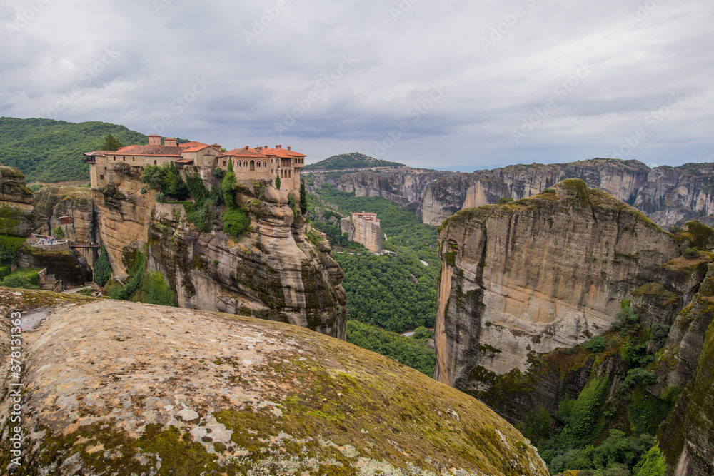 Panorama of  Varlaam  Monastery. Beautiful scenic panoramic view, ancient traditional greek building on the top of huge stone pillar in Meteora,Thessaly, Greece, Europe on a cloudy day.