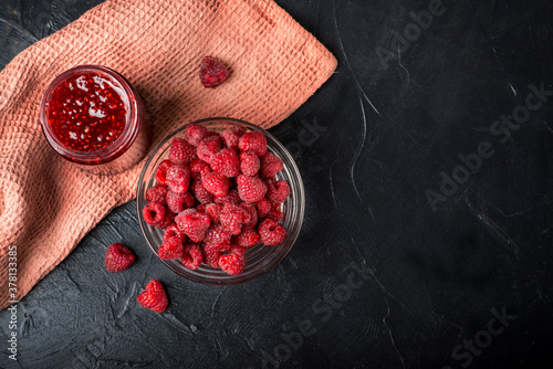 raspberry jam and raspberries. Dark food photo. photo