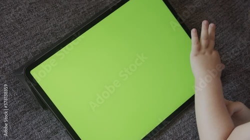 Kid toddler in front of green screen tablet display 4K footage