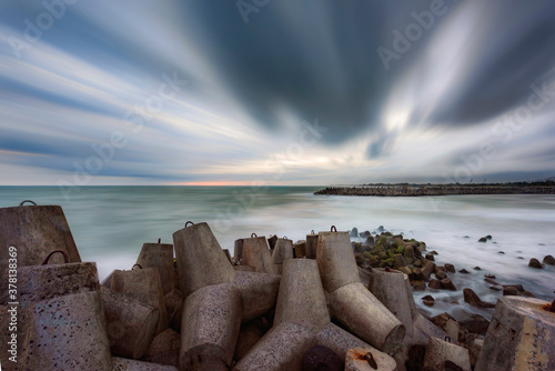 Wave breaker concrete view in Glagah beach, South Java Island, Indonesia photo