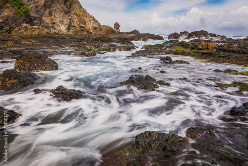 Sea water flowing view in Siung volcanic rock beach, Java Island, Indonesia