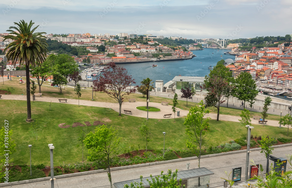 City park over river Douro and cityscape with red tile roofs of historical buildings