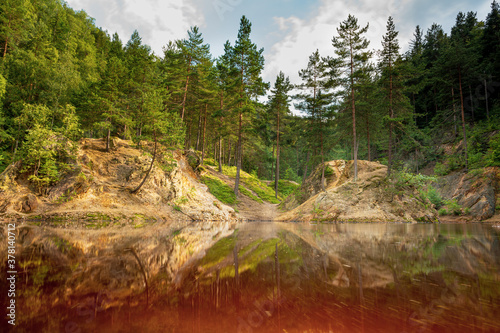 Fototapeta Naklejka Na Ścianę i Meble -  Natural colorful lakes in Europe. Kolorowe Jeziorka in Rudawy Janowickie, Poland. Beautiful purle lake with reflection against forest.