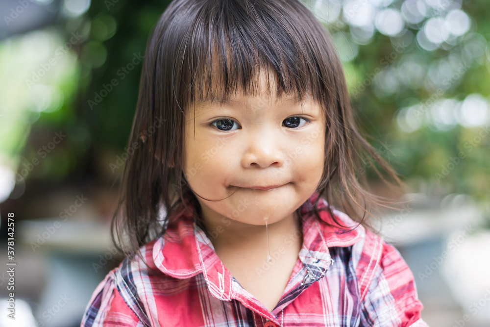 Portrait image of 2-3 years old baby. Face of Happy Asian child girl smiling and looking camera man. At the green backyard garden. Relaxing time. Portrait image of 2-3 years old baby. Face of Happy Asian child girl smiling and looking camera man. At the green backyard garden. Relaxing time.