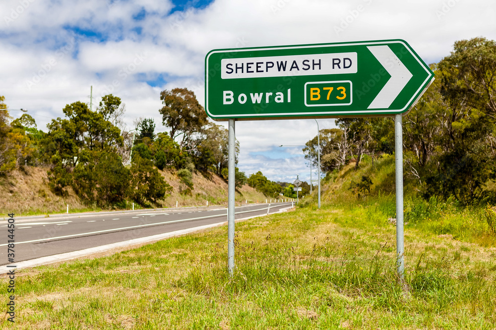 Road sign in rural NSW indicating the direction to Bowral via the Sheepwash Road, Australia.