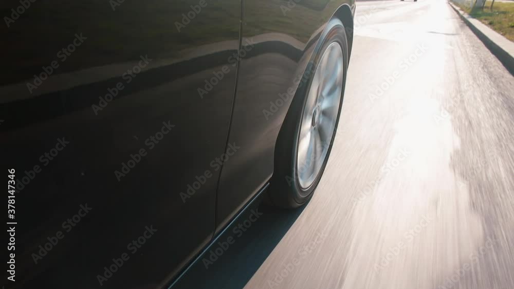 A car wheel drives on the road in the city. The movement of vehicles on the highway. Moving passengers. A car wheel drives on the road in the city. The movement of vehicles on the highway. Moving passengers.