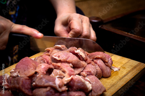 Chopping meat on a wooden chop board