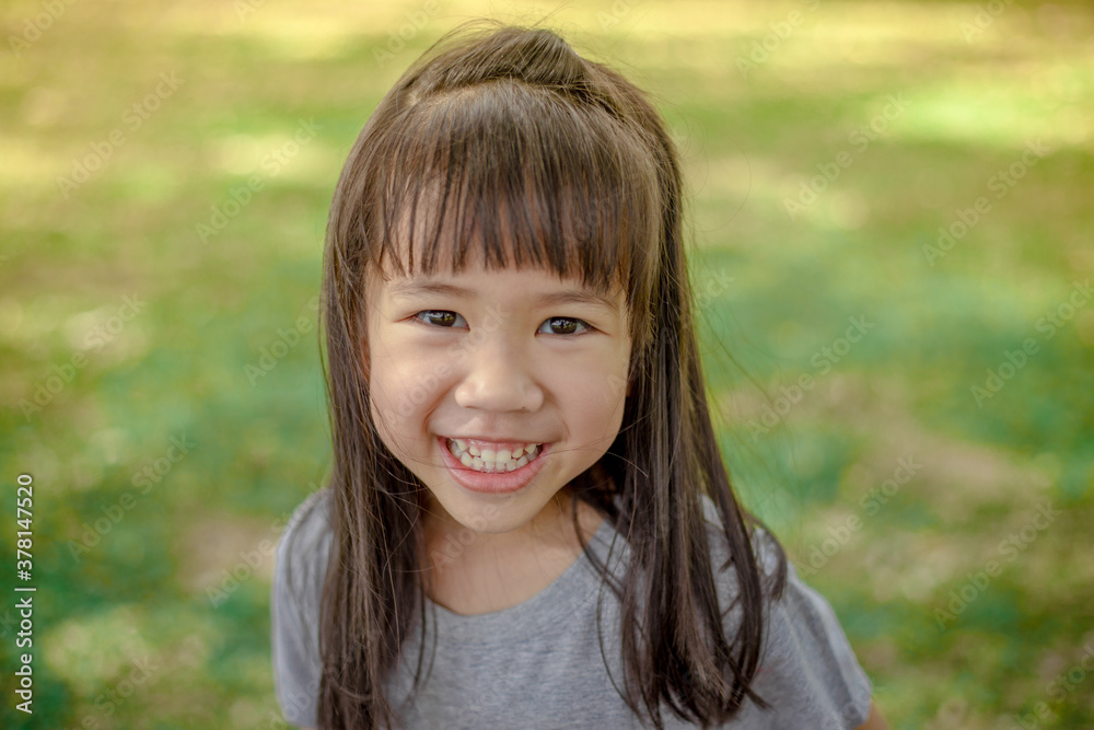 A close-up view of a cute Asian girl. Who are simulating learning outside of the classroom, event planning, designing on the mechanic