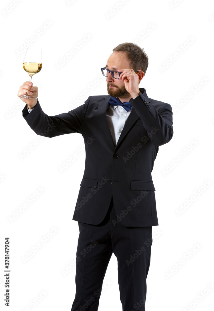 Trying white wine on. Portrait of male sommelier, wine steward or bar worker in white and black suit isolated over white background. Copyspace for ad. Concept of professional occupation, job. Trying white wine on. Portrait of male sommelier, wine steward or bar worker in white and black suit isolated over white background. Copyspace for ad. Concept of professional occupation, job.