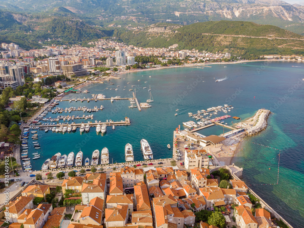 Aerial view of Budva, the old city (stari grad) of Budva, Montenegro. Jagged coast on the Adriatic Sea. Center of Montenegrin tourism, well-preserved medieval walled city, sandy beaches