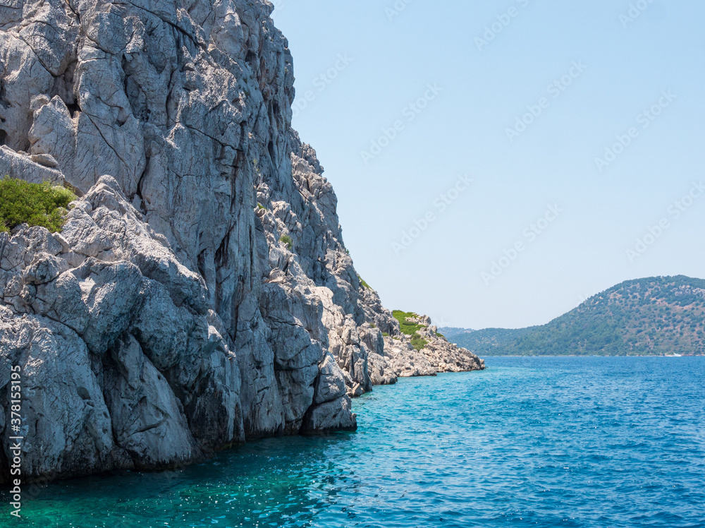 View from a boat to the rocky island at the coast at Marmaris, Turkey.
