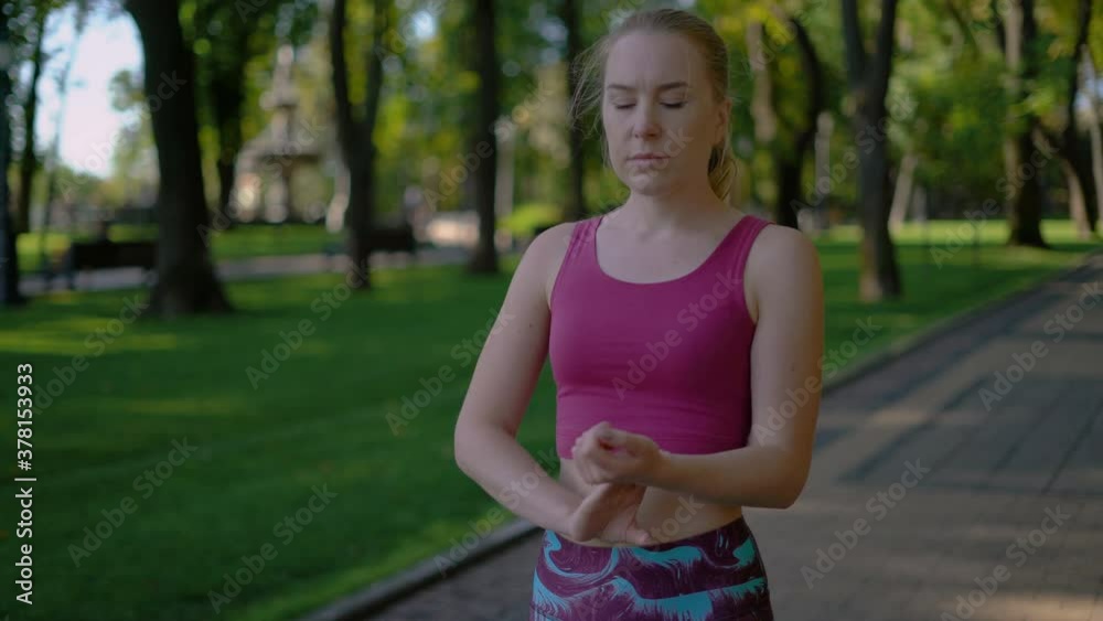 attractive sportive girl athlete checks the pulse. 4K attractive sportive girl athlete checks the pulse. 4K