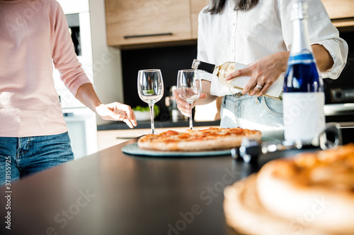 Two female friends going to drink wine together
