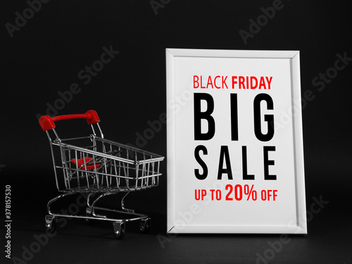 The concept black friday, the advertising frame and the shopping trolley on a black background, buisiness promotional mockup.
