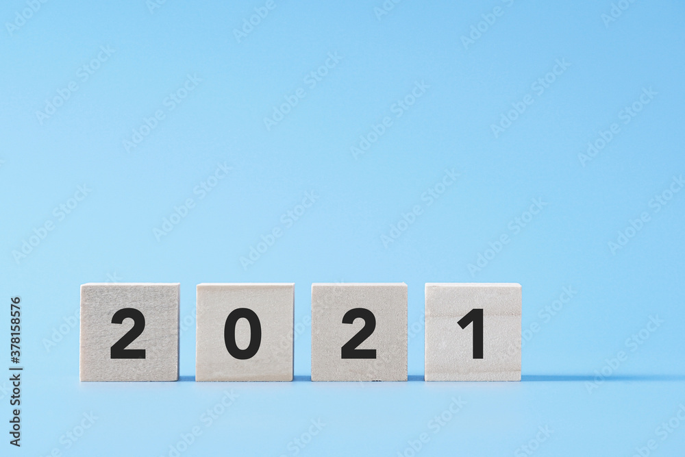 New Year concept with 2021 text on wooden cube block, background with copy space New Year concept with 2021 text on wooden cube block, background with copy space