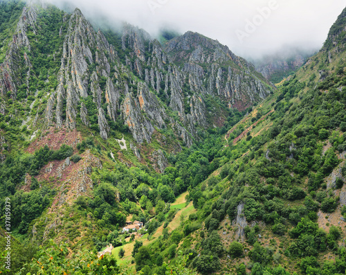 View of valley with craggy mountains near Pola de Somiedo Village, Somiedo nature reserve, spain