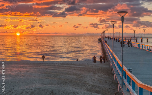 Colorful sunset near a marine pier at the Baltic Sea tourist resort,  Europe