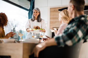 Guests are sitting at the dining table in living room