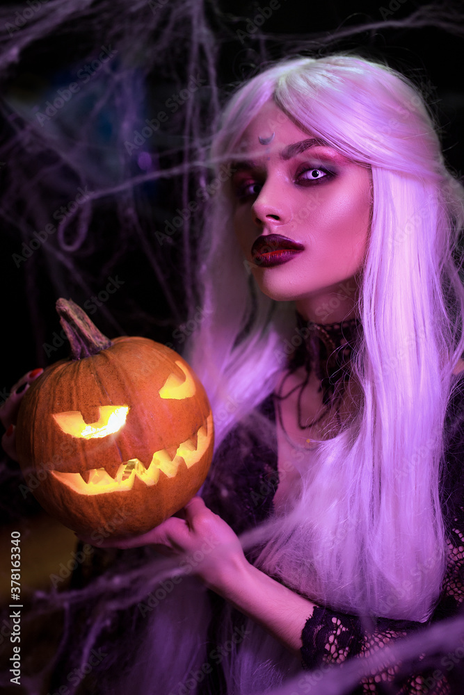 Mysterious Halloween witch woman portrait with pumpkin. Mysterious Halloween witch woman portrait with pumpkin.