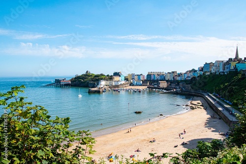 Tenby North beach sandy beach with the pinnacle of Goskar rock sticking out of the sand in the middle. 