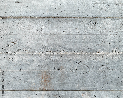 grey concrete wall closeup with wooden planks pattern imprint  seamless background