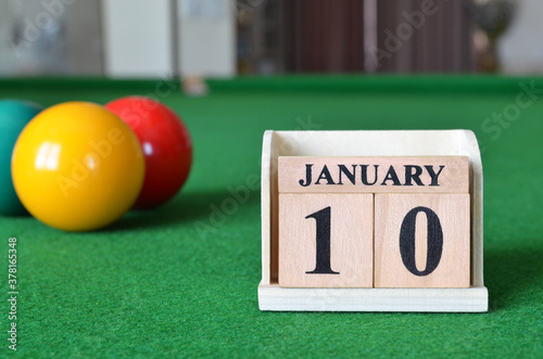 Janaury 10, number cube with balls on snooker table, sport background. photo