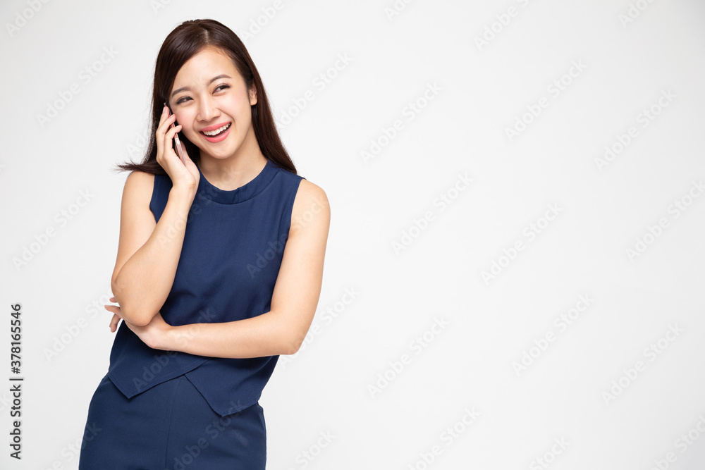 Asian woman smiling while talking on the phone isolated on white background, Phone conversation concept Asian woman smiling while talking on the phone isolated on white background, Phone conversation concept