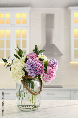 Bouquet with beautiful hydrangea flowers on white marble table © New Africa