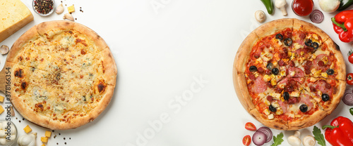 Two tasty pizza and ingredients on white background