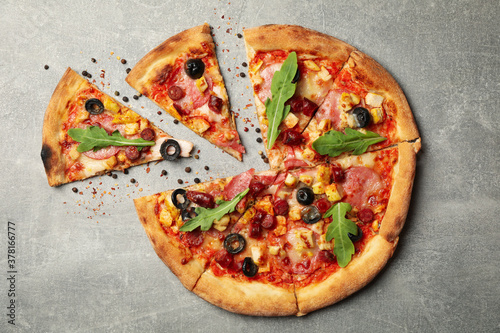 Tasty meat pizza on gray background, top view