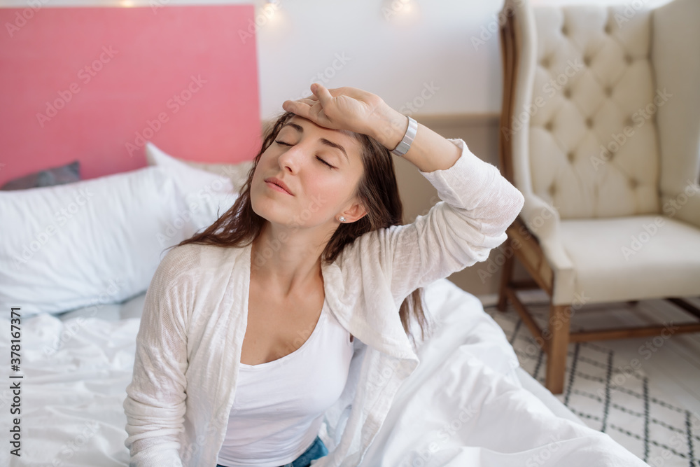 Beautiful woman with long curly hair holding her head under stress
Beautiful woman with long curly hair holding her head under stress