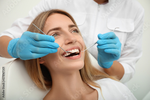 Doctor examining patient s teeth  closeup. Cosmetic dentistry