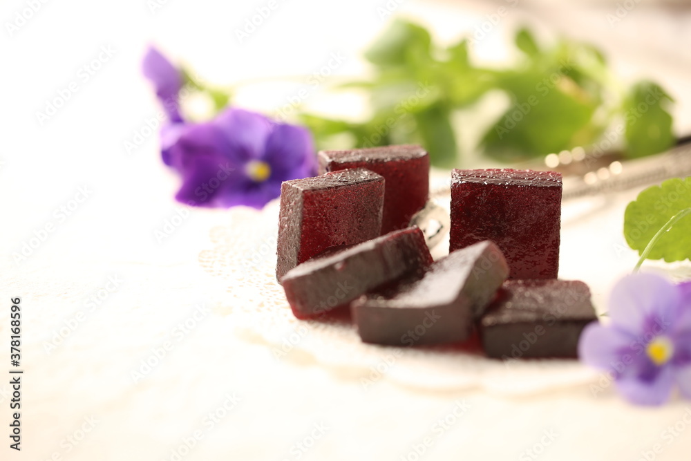 Handmade marmalade of dark color from grapes, on a white background.
Handmade marmalade of dark color from grapes, on a white background.