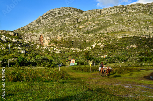 Vista parcial da Serra do Espinhaço em Lapinha da Serra, MG, Brasil. Homem à cavalo no primeiro plano. Região da Serra do Cipó photo