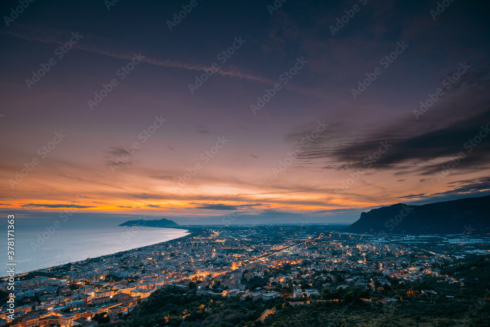Terracina, Italy. Top View Skyline Cityscape City In Evening Sunset. City Illuminations