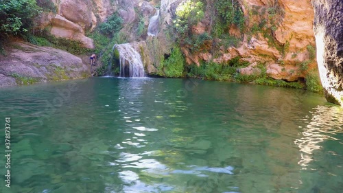 Daredevil Climbs Rocks Near Waterfall