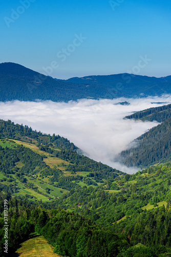 View of the mountain landscape and the mist-shrouded valley. Carpathians.