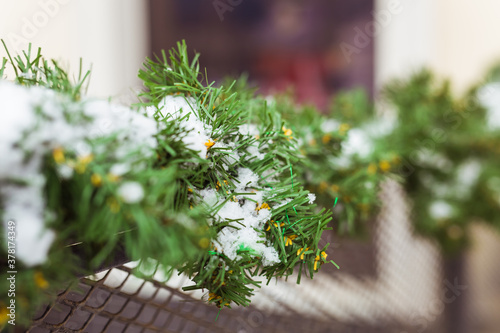 Christmas decor railing branches of a blue Christmas tree. Decoration outside the house to create a festive atmosphere