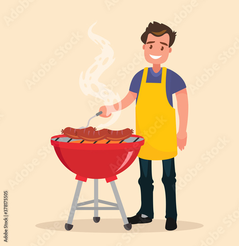 Man is cooking a barbecue grill. Fry meat and sausages on fire.