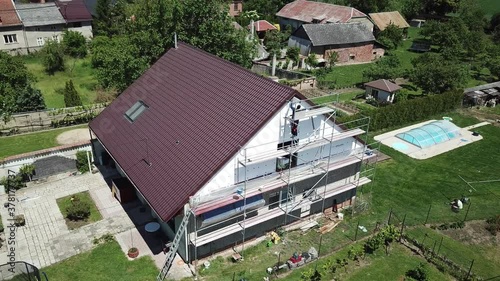Workers to renovate a house. Aerial shot of thermal insulation of the facade of a family house.