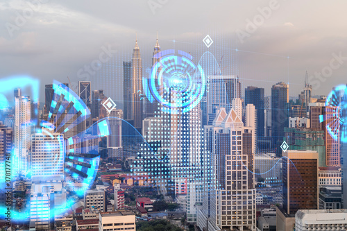 Photography Hologram of abstract technology glowing icons, panoramic cityscape of Kuala Lumpur at sunset, Malaysia, Asia