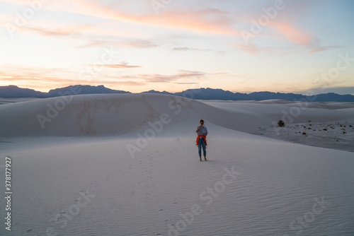 Unrecognizable woman in white sand desert