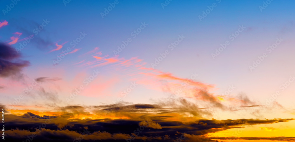 autumn sunset sky landscape background panorama. Natural color of evening dark clouds. Cloudscape with sun below horizon. Ultra wide panoramic view