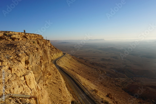 sunrise in Negev desert near Mitzpe Ramon, view on Maktesh Ramon, impact crater with highway