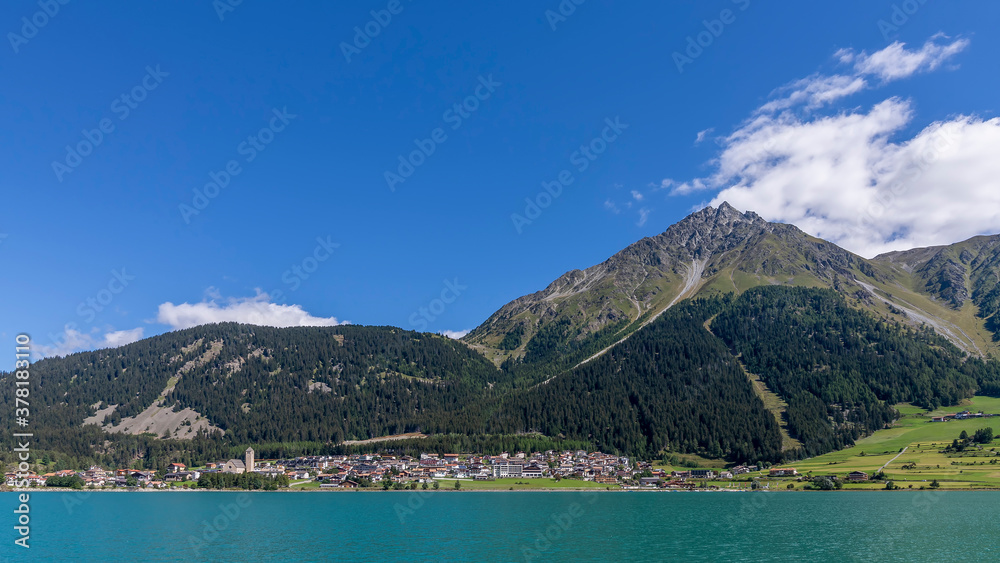Beautiful panoramic view of Lake Resia and the homonymous village in the province of Bolzano, South Tyrol, Italy