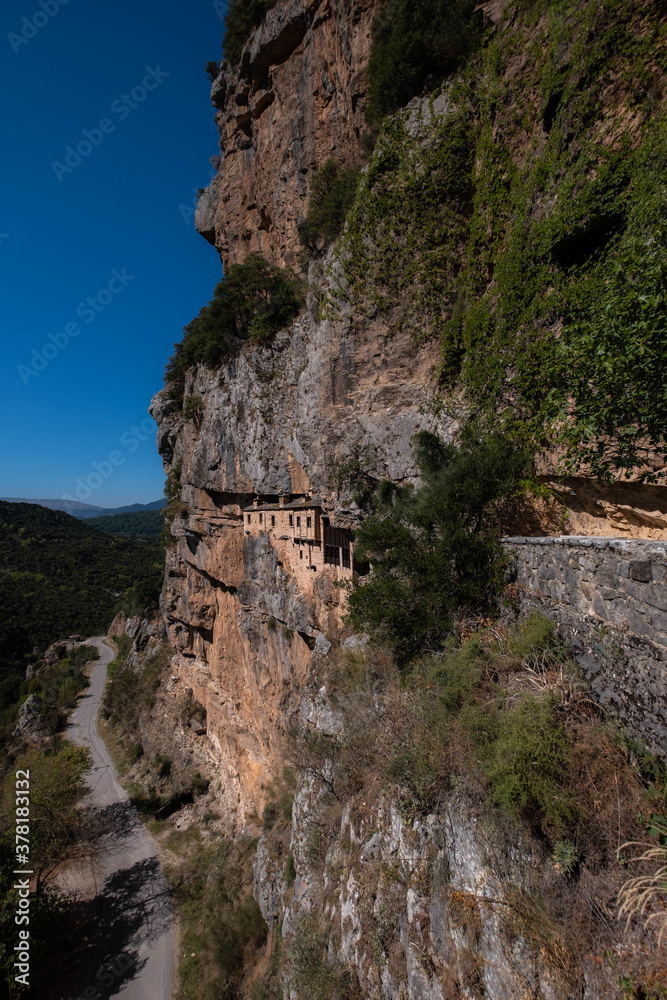 It was constructed in 1212 in the honor of the Assumption of Virgin Mary. The monastery of Kipina, just outside the village of Kalarrites, seems to be a part of the rock inside which it is built.