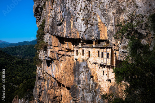 It was constructed in 1212 in the honor of the Assumption of Virgin Mary. The monastery of Kipina, just outside the village of Kalarrites, seems to be a part of the rock inside which it is built.